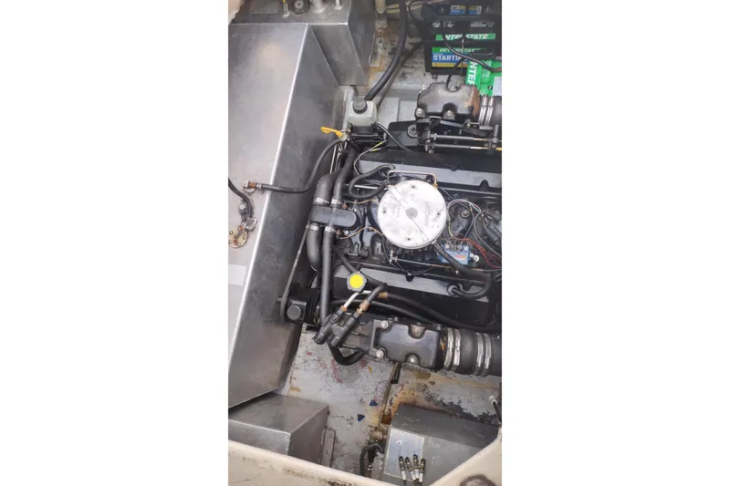 Slide: The Image of Engine compartment of a 1996 Crownline 250 CR boat, showing mechanical components. - 25
