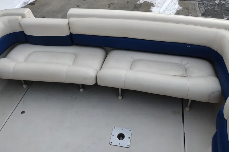 Slide: The Image of Crownline 250 CR 1996 boat interior with worn white and blue seating. - 26