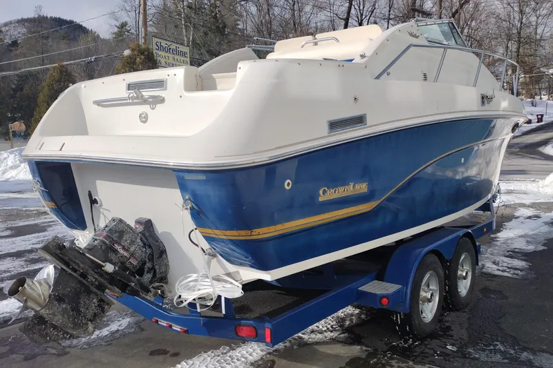 Slide: The Image of 1996 Crownline 250 CR boat on trailer, blue and white design, parked in snowy area. - 6