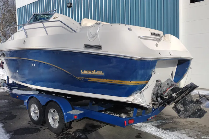 Slide: The Image of 1996 Crownline 250 CR boat on trailer, blue and white exterior, parked outdoors. - 8