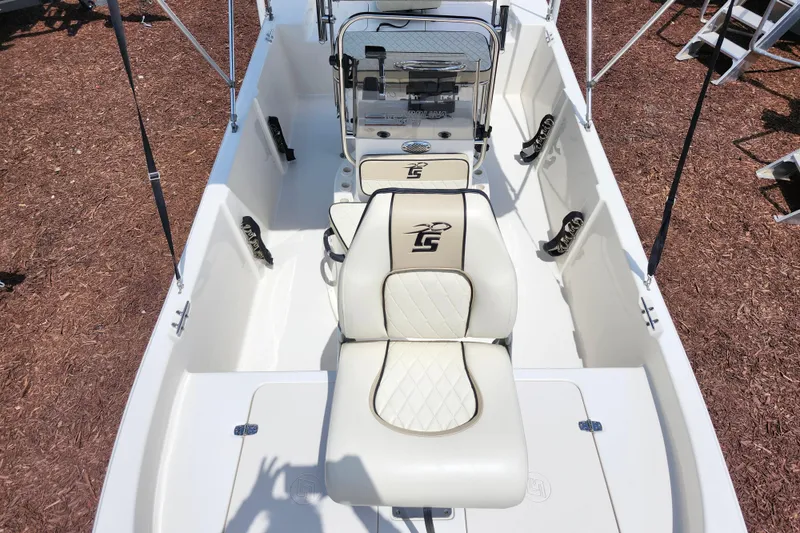Slide: The Image of 2022 Carolina Skiff 178 JLS boat interior with white seating and steering console. - 11