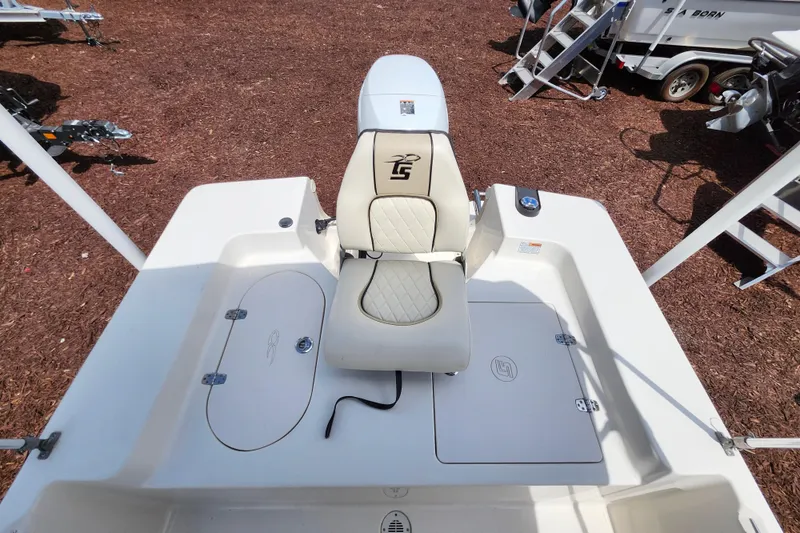 Slide: The Image of 2022 Carolina Skiff 178 JLS boat interior with cushioned seat and storage compartments. - 13