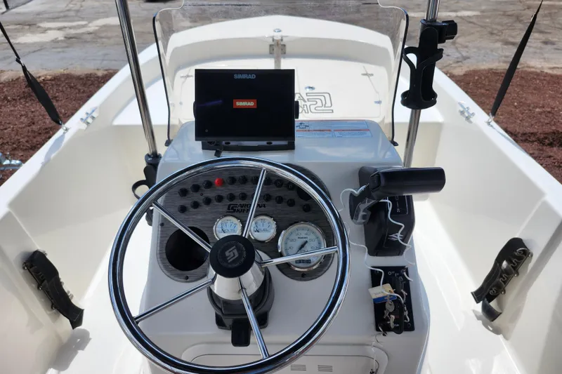 Slide: The Image of 2022 Carolina Skiff 178 JLS boat console with steering wheel and Simrad display. - 23