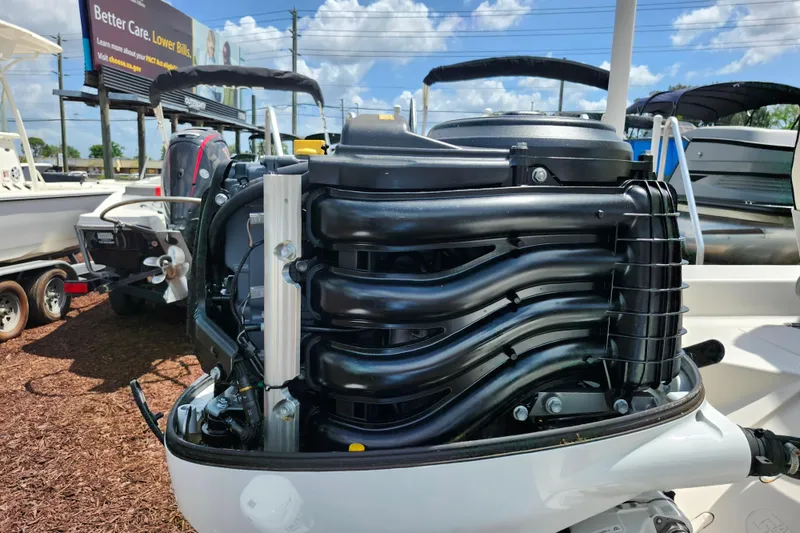 Slide: The Image of 2022 Carolina Skiff 178 JLS boat engine, detailed view under sunny skies. - 31