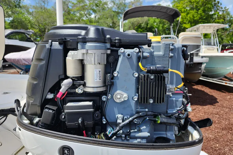 Slide: The Image of Close-up of a 2022 Carolina Skiff 178 JLS boat engine, showcasing detailed components. - 32