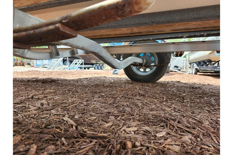 Slide: The Image of 2022 Carolina Skiff 178 JLS boat trailer on mulch-covered ground. - 33