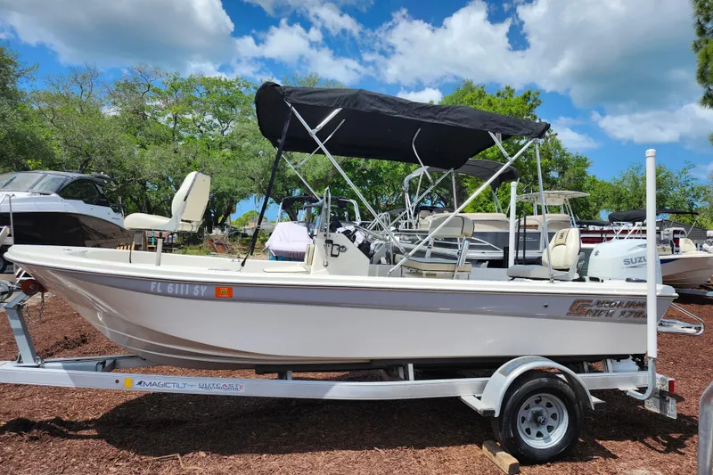 Slide: The Image of 2022 Carolina Skiff 178 JLS boat on trailer with canopy, parked outdoors. - 4
