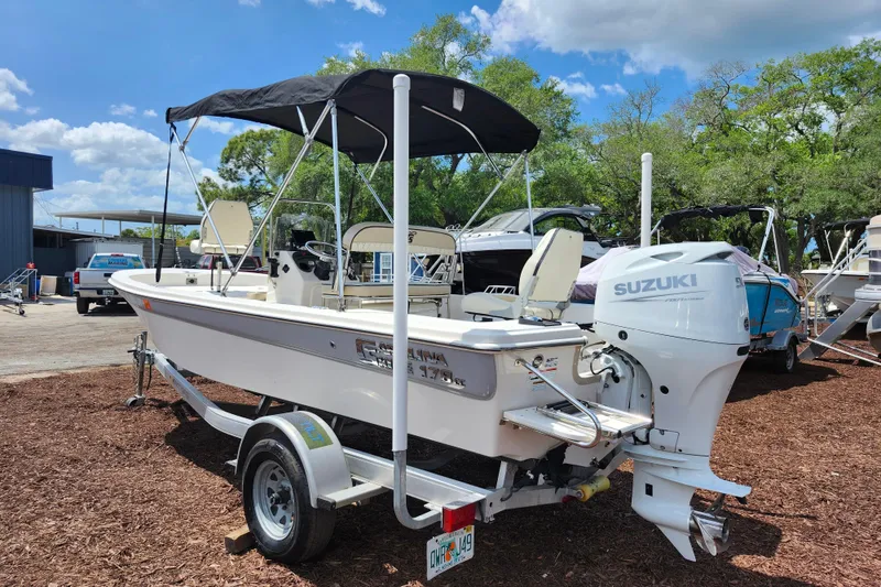 Slide: The Image of 2022 Carolina Skiff 178 JLS boat with Suzuki engine on trailer, outdoors. - 5