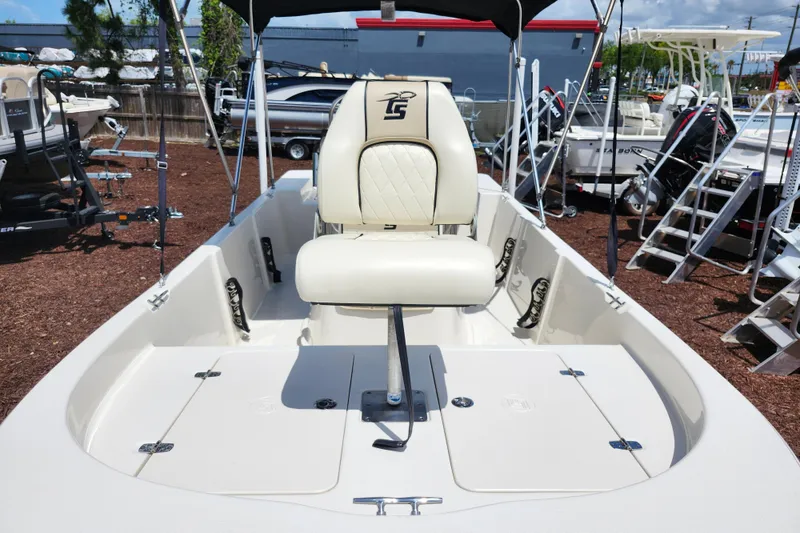 Slide: The Image of 2022 Carolina Skiff 178 JLS boat interior with seating and storage compartments. - 9