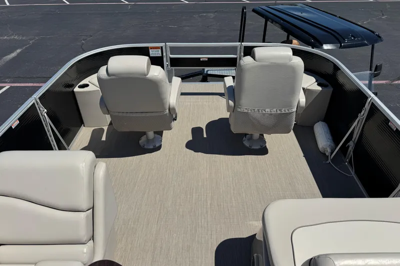Slide: The Image of 2017 Bennington 22 SX Fish pontoon boat interior with beige seating and spacious deck. - 12