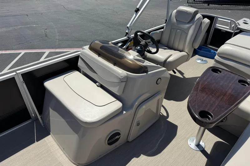 Slide: The Image of 2017 Bennington 22 SX Fish boat interior with helm, seating, and table. - 13