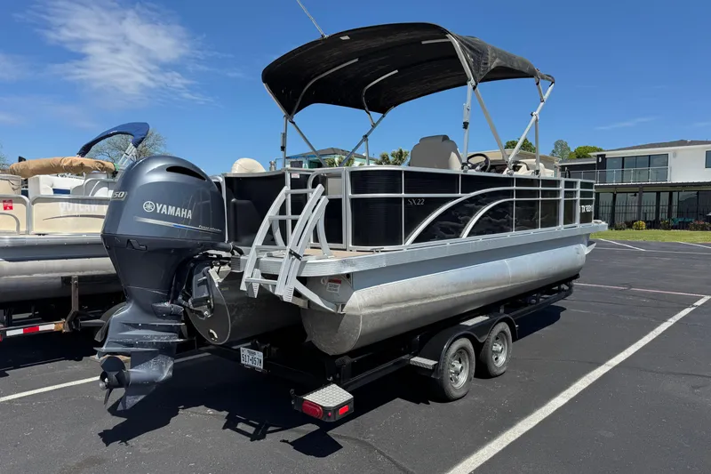 Slide: The Image of 2017 Bennington 22 SX Fish pontoon boat with Yamaha motor on trailer. - 2
