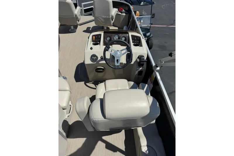 Slide: The Image of Captain's seat and console of 2017 Bennington 22 SX Fish boat, featuring steering wheel and controls. - 6