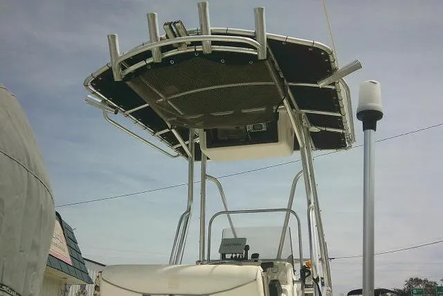 Slide: The Image of 2009 Carolina Skiff 198 DLV Elite boat with T-top and fishing rod holders. - 10