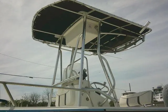 Slide: The Image of 2009 Carolina Skiff 198 DLV Elite boat with T-top and console, viewed from the side. - 5
