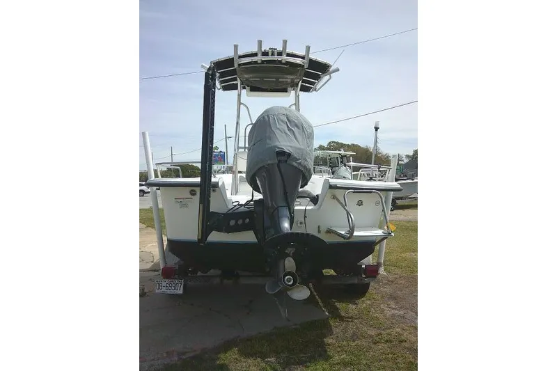 Slide: The Image of 2009 Carolina Skiff 198 DLV Elite boat with covered outboard motor, rear view. - 8