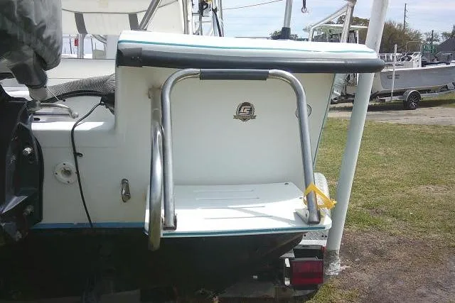 Slide: The Image of 2009 Carolina Skiff 198 DLV Elite boat with rear swim platform and ladder. - 9