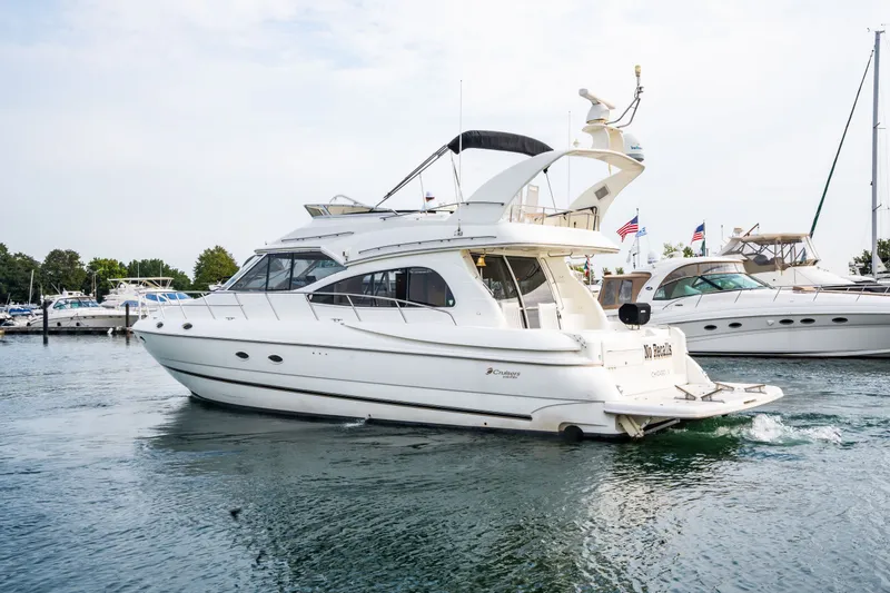 Slide: The Image of 2001 Cruisers Yachts 5000 Sedan Sport on calm waters. - 1