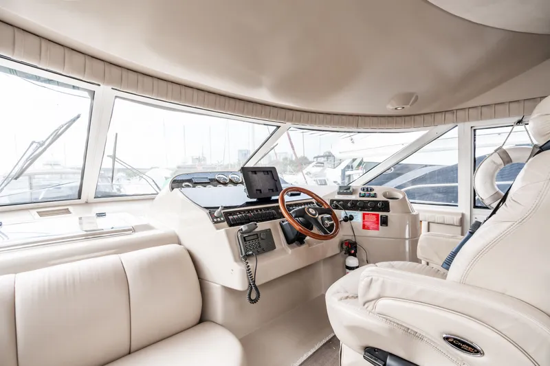 Slide: The Image of Interior of 2001 Cruisers Yachts 5000 Sedan Sport, luxurious helm station. - 10