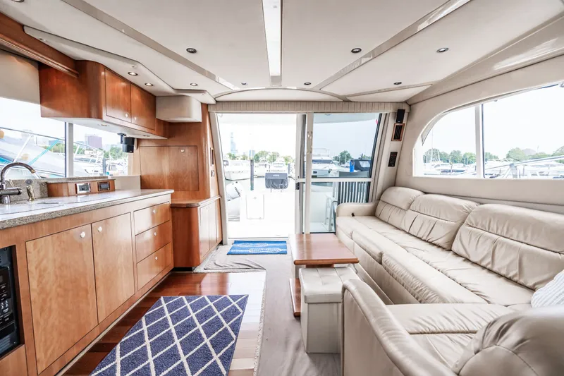Slide: The Image of Interior of 2001 Cruisers Yachts 5000 Sedan Sport with leather sofa and wooden kitchen. - 19
