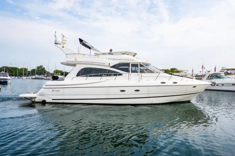 Slide: The Image of 2001 Cruisers Yachts 5000 Sedan Sport on calm water. - 22