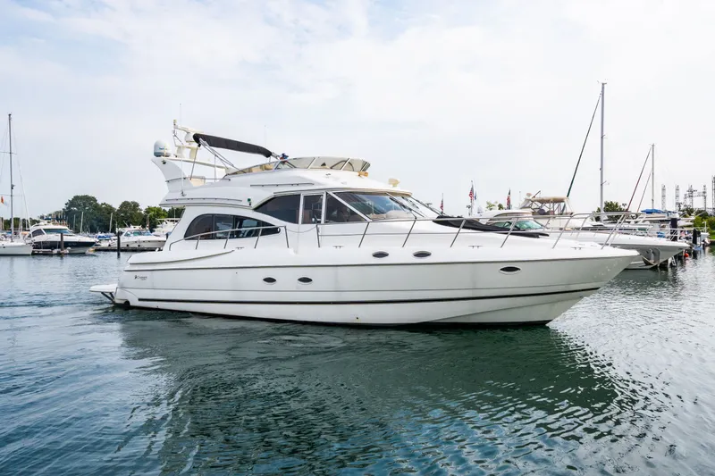 Slide: The Image of 2001 Cruisers Yachts 5000 Sedan Sport in harbor. - 23