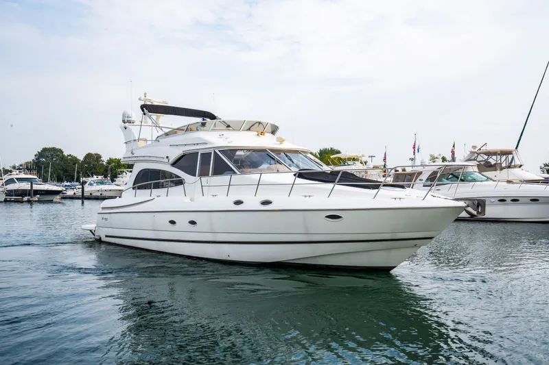 Slide: The Image of 2001 Cruisers Yachts 5000 Sedan Sport on calm water. - 24