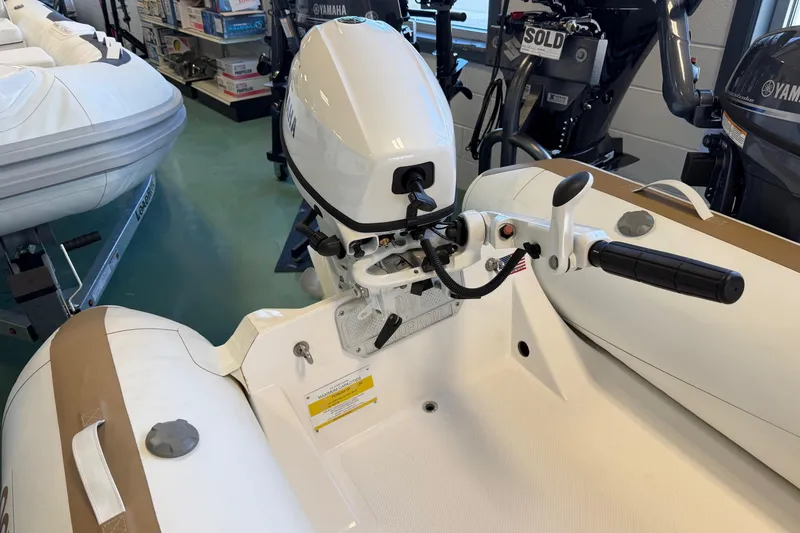 Slide: The Image of Novurania TR 270 boat with Yamaha outboard motor, displayed in a showroom, 2025 model. - 4