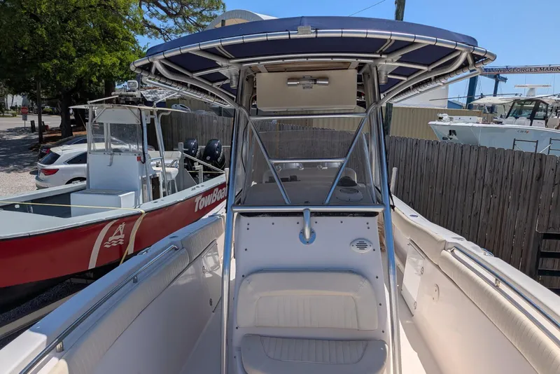 Slide: The Image of 2004 Grady-White Chase 273 boat with T-top, docked near other vessels. - 10