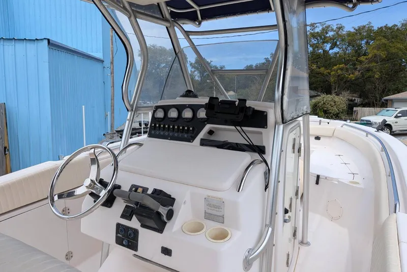 Slide: The Image of 2004 Grady-White Chase 273 boat cockpit with steering wheel and control panel. - 5