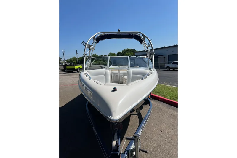 Slide: The Image of 2004 Tigé 21i Limited Edition boat on trailer, parked outdoors under clear blue sky. - 7