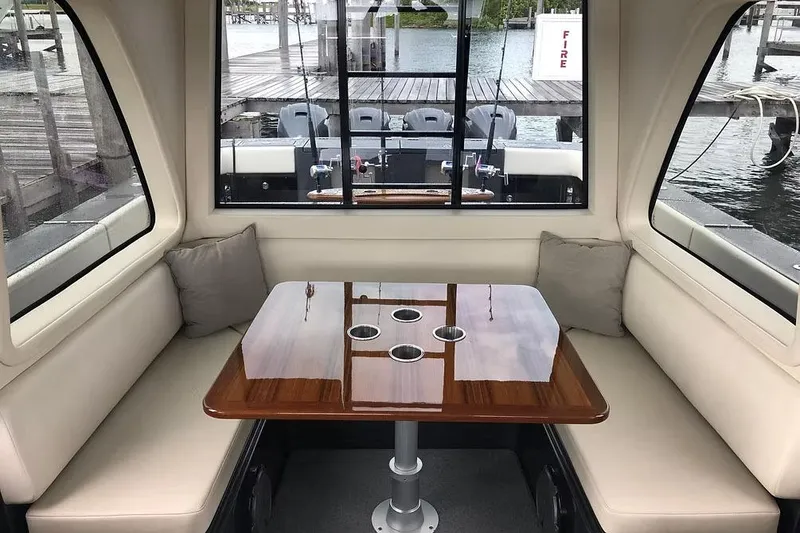 Slide: The Image of Manufacturer Provided Image: Luxurious interior of 2026 Ocean Yachts 52 CC with elegant seating and polished table. - 12
