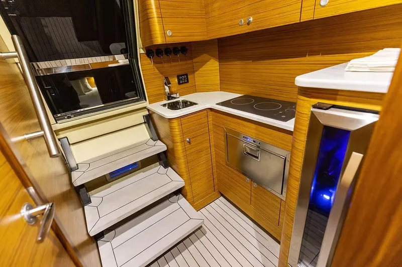 Slide: The Image of Manufacturer Provided Image: Modern kitchen interior of 2026 Ocean Yachts 52 CC, featuring wood paneling and sleek appliances. - 13