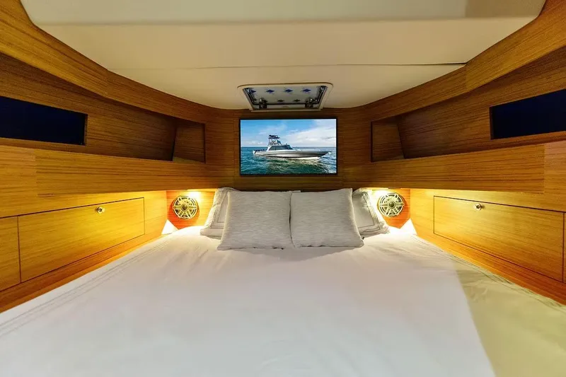 Slide: The Image of Manufacturer Provided Image: Luxurious cabin interior of 2026 Ocean Yachts 52 CC with cozy bedding and wooden finish. - 14
