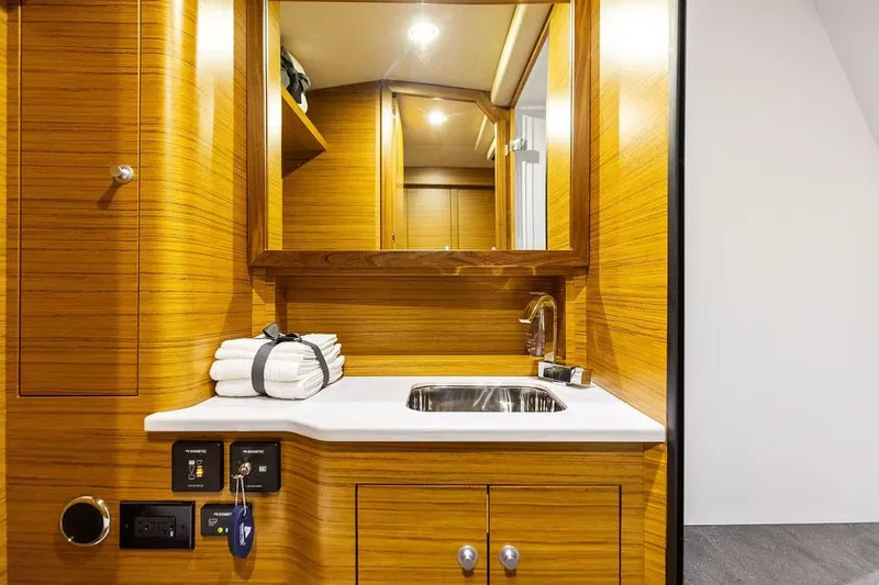 Slide: The Image of Manufacturer Provided Image: Luxurious wooden interior of 2026 Ocean Yachts 52 CC with sink and towels. - 15