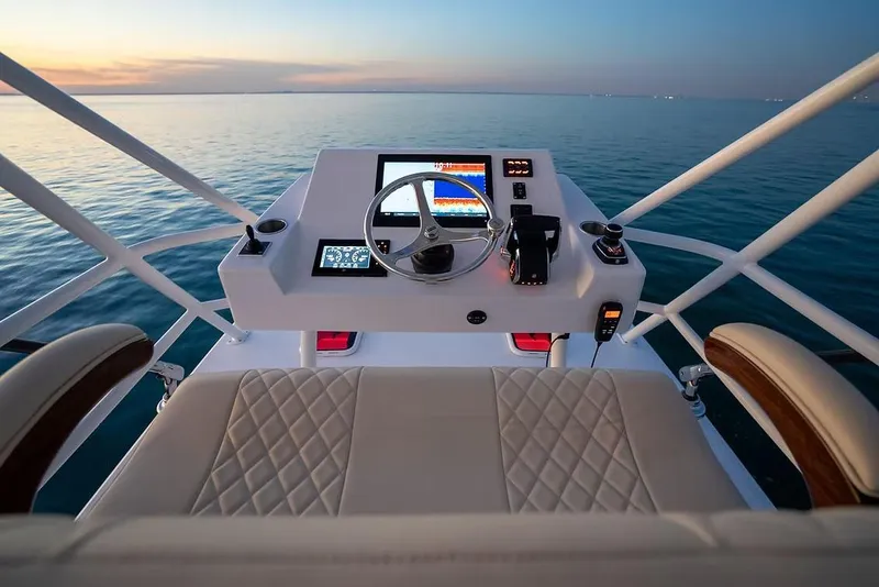 Slide: The Image of Manufacturer Provided Image: Helm of 2026 Ocean Yachts 52 CC at sunset, featuring modern navigation controls. - 9