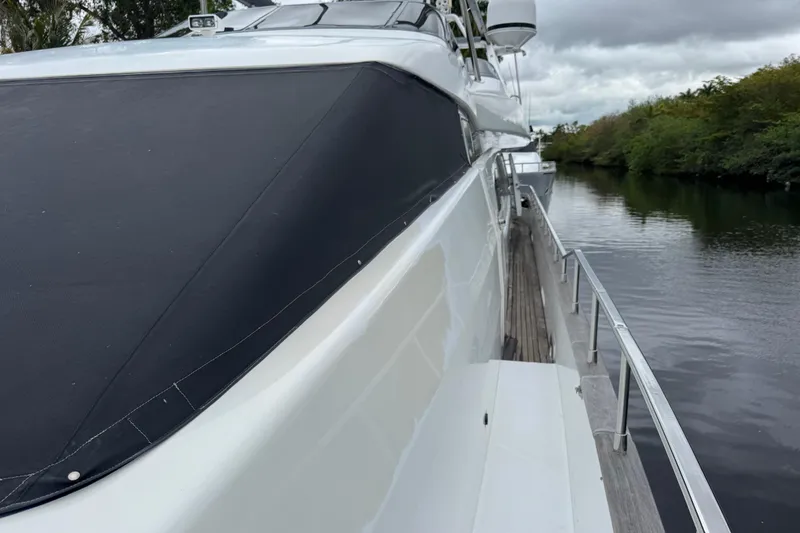 Slide: The Image of Side view of a 1998 Azimut 85 Ultimate yacht on a calm river. - 10