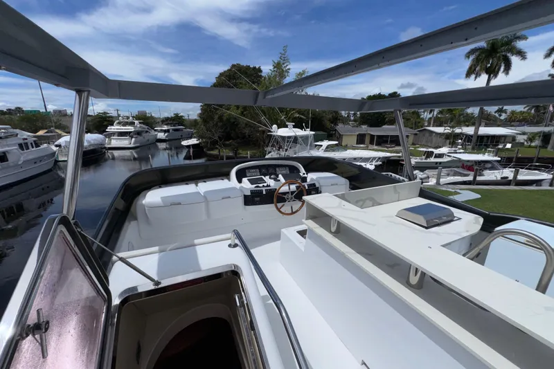 Slide: The Image of Flybridge view of 1998 Azimut 85 Ultimate yacht docked in a marina. - 13