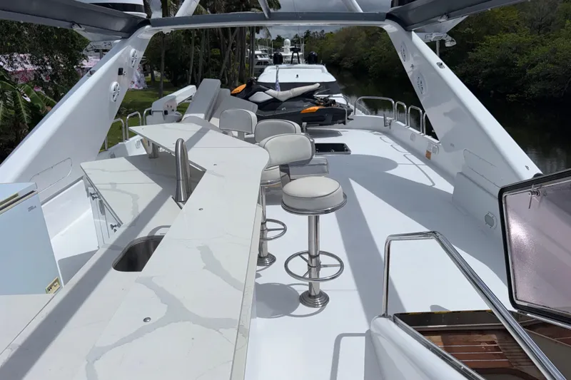 Slide: The Image of Luxurious 1998 Azimut 85 Ultimate yacht deck with bar stools and sleek design. - 14