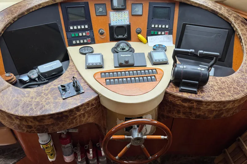 Slide: The Image of Cockpit of 1998 Azimut 85 Ultimate yacht with navigation controls and steering wheel. - 23