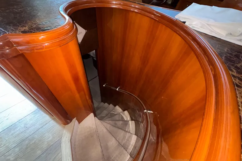 Slide: The Image of Curved wooden staircase inside 1998 Azimut 85 Ultimate yacht, showcasing elegant craftsmanship. - 26