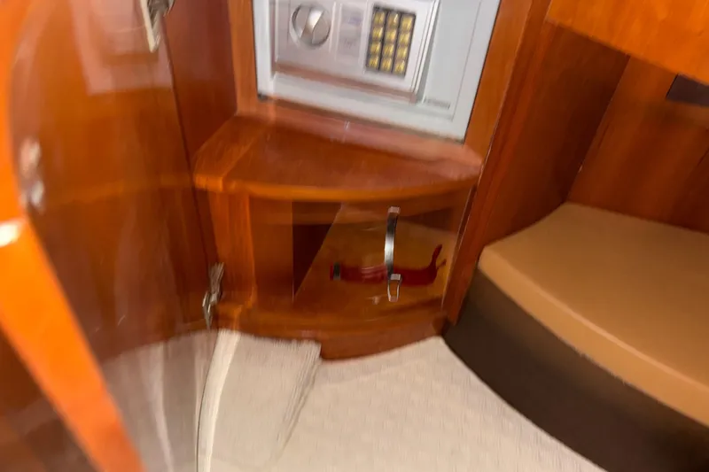 Slide: The Image of Interior of 1998 Azimut 85 Ultimate yacht featuring a safe and wooden cabinetry. - 33