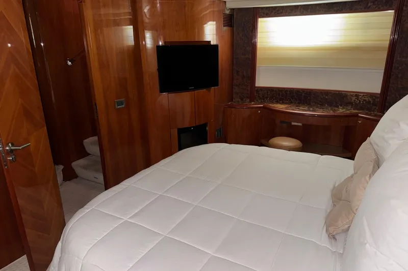 Slide: The Image of Luxurious bedroom interior of 1998 Azimut 85 Ultimate yacht with wood paneling and TV. - 35