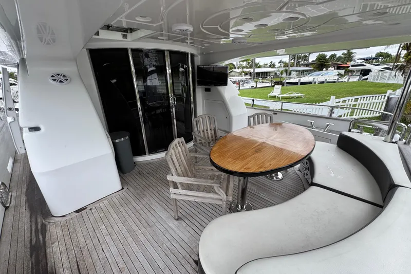 Slide: The Image of Outdoor seating area on 1998 Azimut 85 Ultimate yacht with wooden table and chairs. - 4