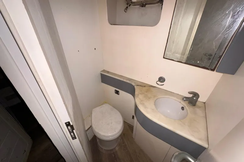 Slide: The Image of Bathroom interior of a 1998 Azimut 85 Ultimate yacht, featuring sink and toilet. - 48