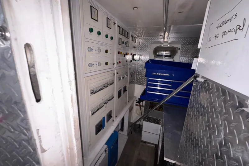 Slide: The Image of Electrical control room inside a 1998 Azimut 85 Ultimate yacht, featuring panels and tool storage. - 50
