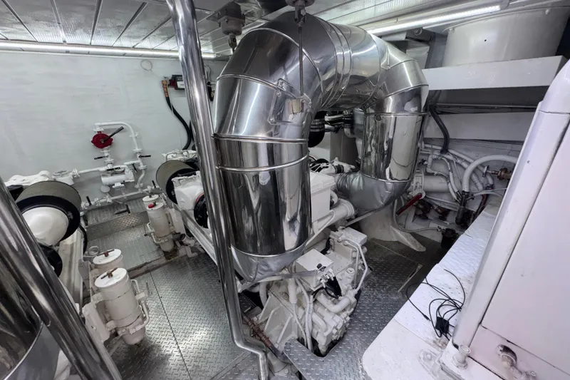 Slide: The Image of Engine room of a 1998 Azimut 85 Ultimate yacht, featuring polished metal components. - 52