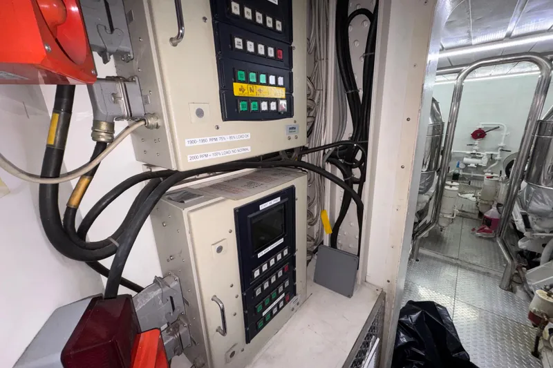 Slide: The Image of Engine room of 1998 Azimut 85 Ultimate yacht with control panels and machinery. - 53