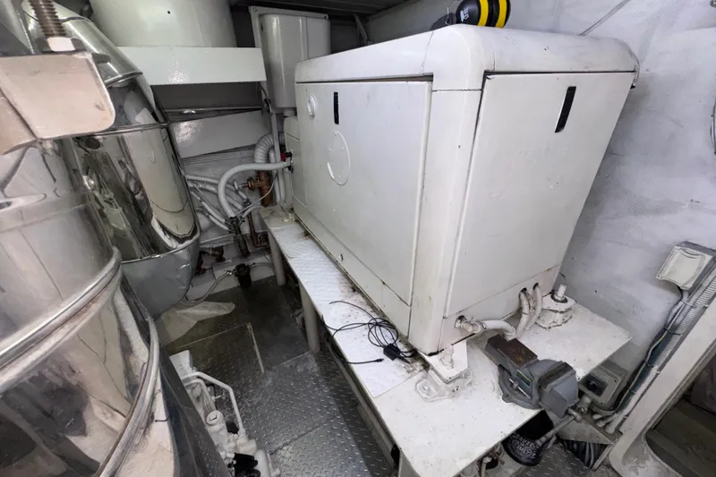 Slide: The Image of Engine room of a 1998 Azimut 85 Ultimate yacht, featuring machinery and piping. - 54