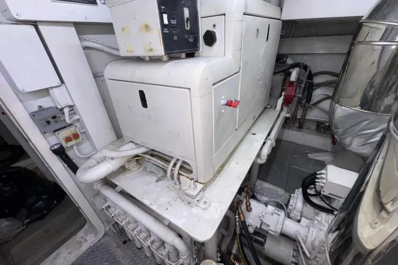 Slide: The Image of Engine room of a 1998 Azimut 85 Ultimate yacht, showcasing machinery and piping. - 55